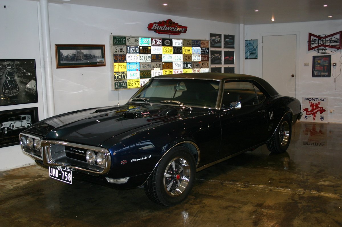 Dark blue Pontiac Firebird in the showroom