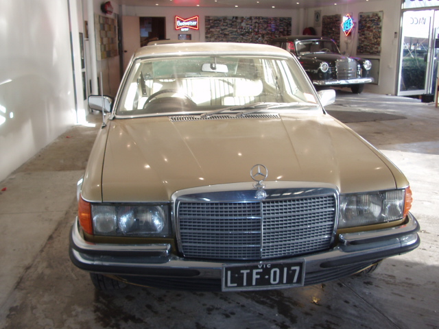 Tan Mercedes-Benz sedan in the showroom