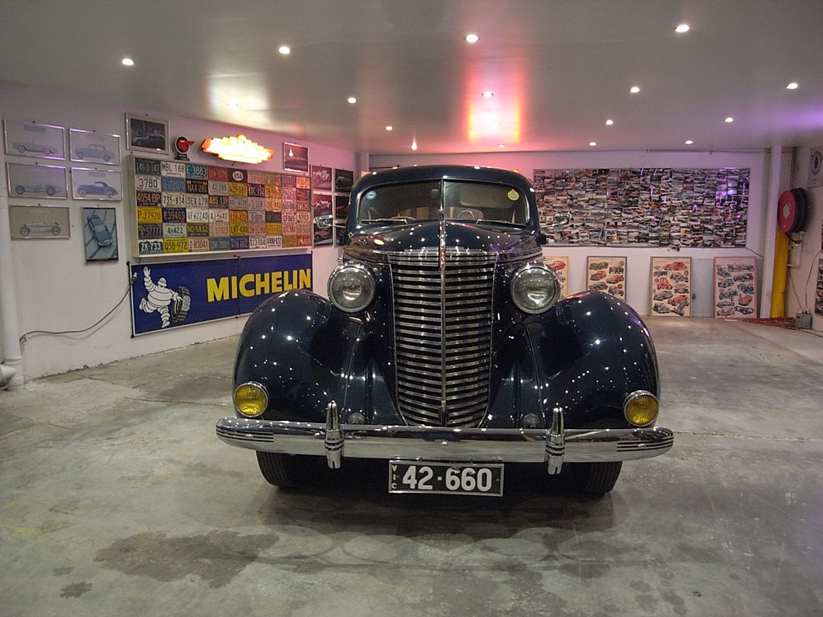 A restored 1930s sedan in the showroom